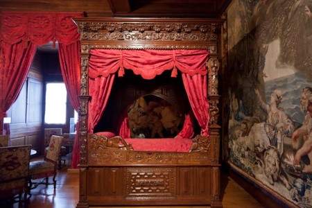 Tapestries and carved wood decorate a royal bedroom in the Château de Pau.